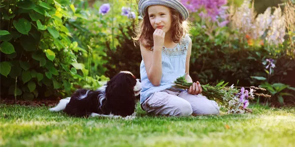 girl playing outside with dog